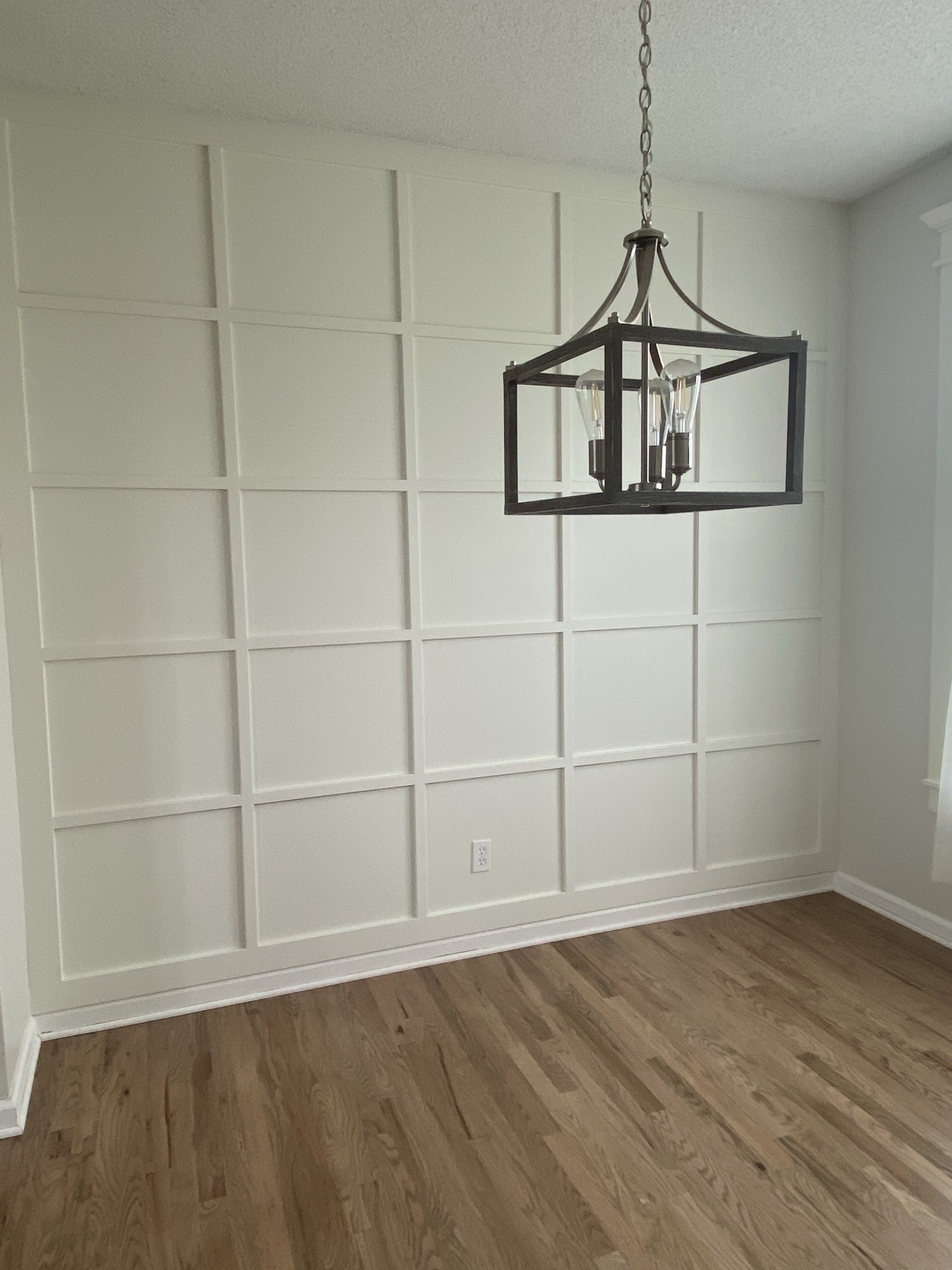 Custom square-panel accent wall with iron lantern pendant — Nova Haven project in Leawood, KS