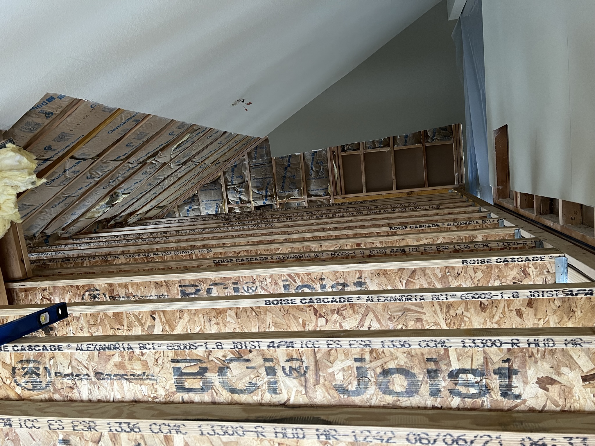 Exposed engineered I-joist ceiling structure during a whole-home remodel